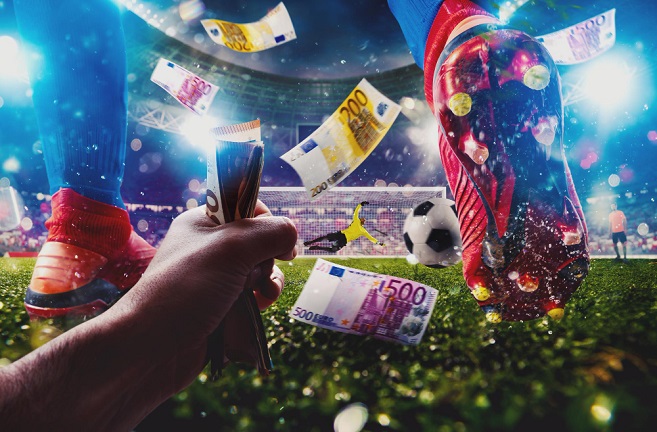 Hand holding money right behind a football player on a tv screen